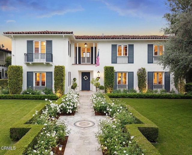 670 San Marino Ave, San Marino, CA 91108 - mediterranean / spanish house featuring stucco siding, a front lawn, a tile roof, and a balcony