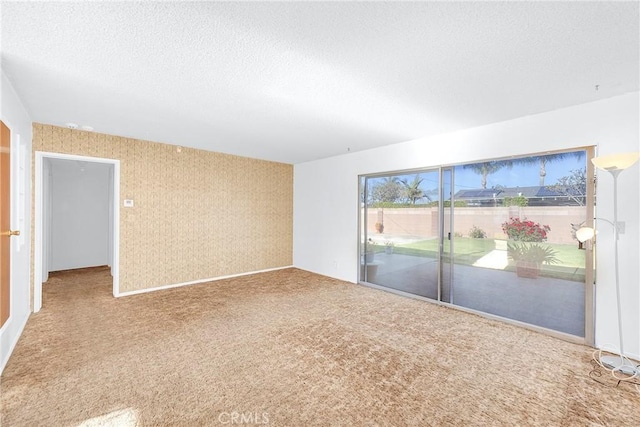10300 Miranda Ave, Buena Park, CA 90620 - carpeted empty room featuring wallpapered walls and a textured ceiling