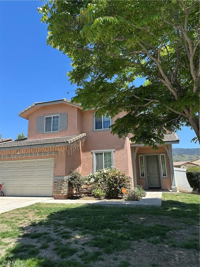 1128 Amberwood Ct, San Bernardino, CA 92407 - view of front facade featuring stucco siding, driveway, a garage, and stone siding