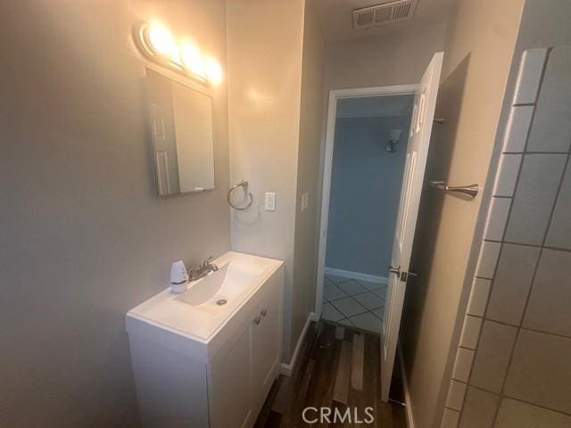 410 Orange Ave, Los Banos, CA 93635 - bathroom featuring vanity and wood finished floors
