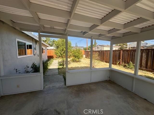410 Orange Ave, Los Banos, CA 93635 - unfurnished sunroom featuring beamed ceiling