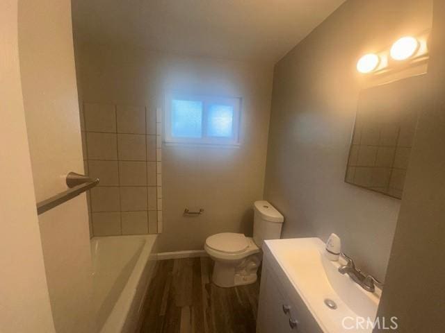 410 Orange Ave, Los Banos, CA 93635 - full bathroom featuring toilet, wood finished floors, and vanity