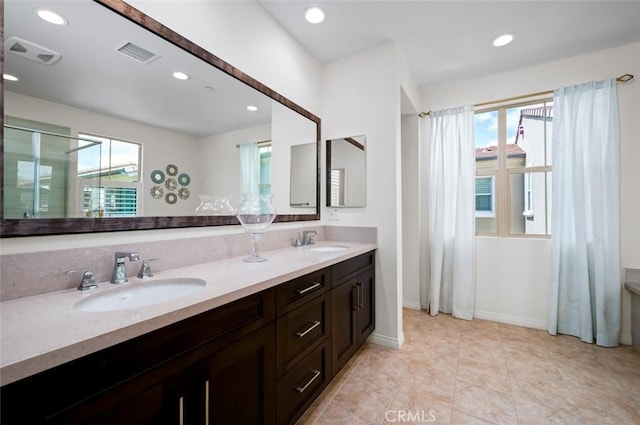 126 Brambles, Irvine, CA 92618 - bathroom with recessed lighting, double vanity, baseboards, and a shower
