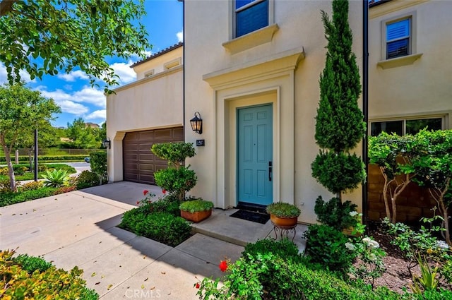 126 Brambles, Irvine, CA 92618 - doorway to property featuring stucco siding and driveway