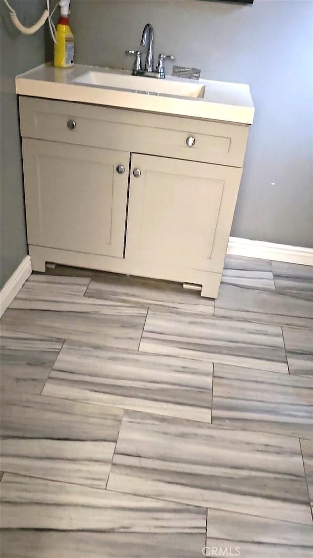 3350 Linda Vis, Los Angeles, CA 90032 - detailed view of baseboards, a sink, and wood finished floors