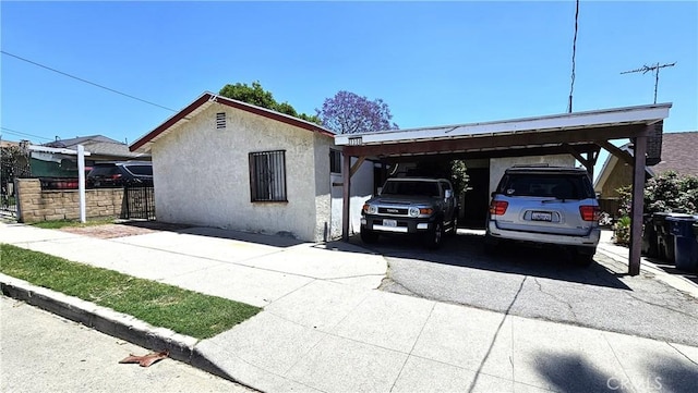 3350 Linda Vis, Los Angeles, CA 90032 - view of front facade featuring concrete driveway, stucco siding, and an attached carport