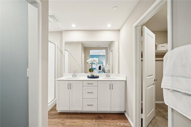 16157 Lumia Way, Fontana, CA 92336 - full bath with a stall shower, double vanity, and wood finished floors