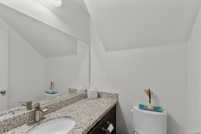 861 Colton Ave, Colton, CA 92324 - half bathroom featuring toilet, vanity, and vaulted ceiling
