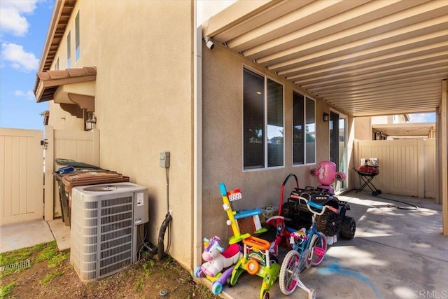 861 Colton Ave, Colton, CA 92324 - view of side of property with central AC, fence, stucco siding, and a patio
