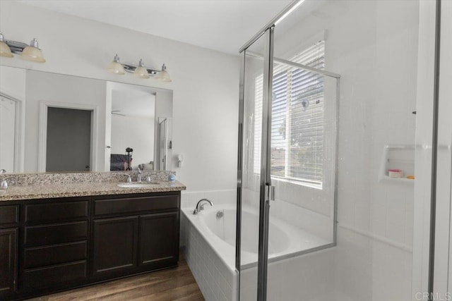 861 Colton Ave, Colton, CA 92324 - ensuite bathroom with plenty of natural light, a bath, double vanity, and wood finished floors