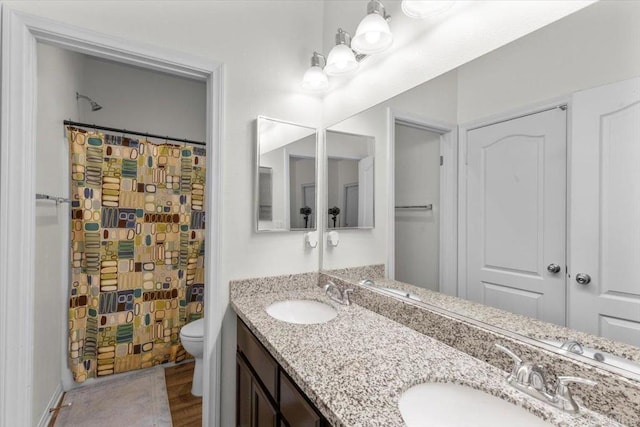861 Colton Ave, Colton, CA 92324 - full bath with toilet, double vanity, a shower with curtain, and wood finished floors