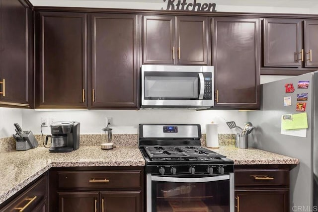 861 Colton Ave, Colton, CA 92324 - kitchen with stainless steel appliances, dark brown cabinetry, and light stone countertops