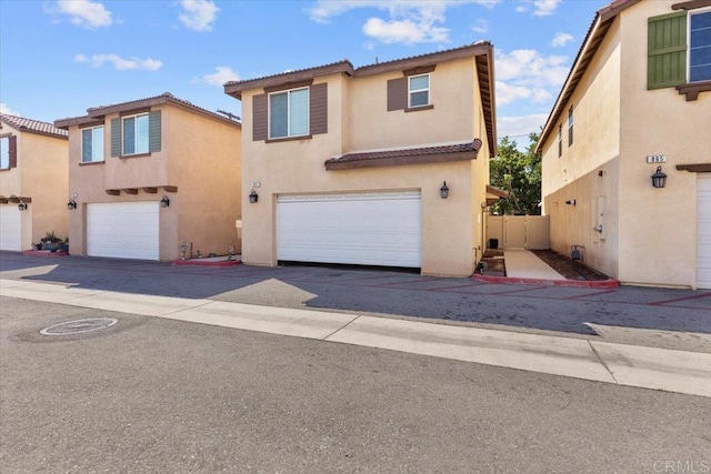 861 Colton Ave, Colton, CA 92324 - view of front facade with a garage, stucco siding, a tile roof, and fence