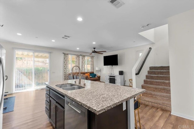 861 Colton Ave, Colton, CA 92324 - kitchen featuring dishwasher, a sink, light wood-type flooring, open floor plan, and a kitchen island with sink
