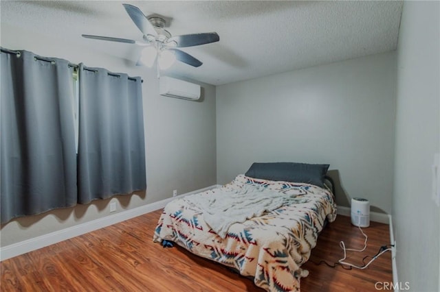 5805 Vista Del Cerro, Oroville, CA 95966 - bedroom with a wall unit AC, a textured ceiling, baseboards, wood finished floors, and a ceiling fan