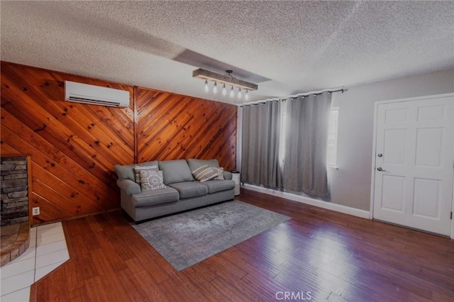 5805 Vista Del Cerro, Oroville, CA 95966 - living room featuring a wall mounted AC, baseboards, wood finished floors, a textured ceiling, and wooden walls