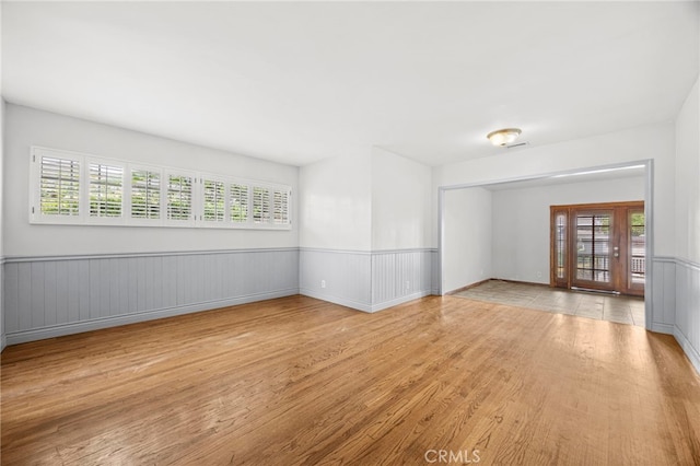 10441 La Mirada Blvd, Whittier, CA 90604 - empty room featuring wood finished floors, healthy amount of natural light, and a wainscoted wall