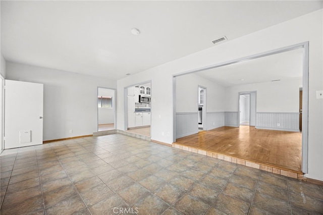 10441 La Mirada Blvd, Whittier, CA 90604 - unfurnished living room with wainscoting and baseboards