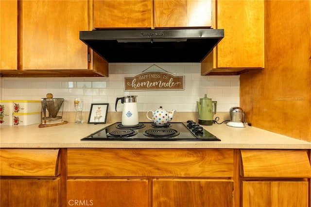 3080 State Highway 45, Glenn, CA 95943 - kitchen featuring under cabinet range hood, light countertops, black electric cooktop, and decorative backsplash