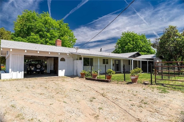 3080 State Highway 45, Glenn, CA 95943 - rear view of property featuring driveway, a chimney, board and batten siding, and fence