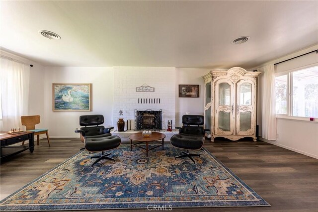 3080 State Highway 45, Glenn, CA 95943 - living area with a brick fireplace, dark wood-style flooring, and baseboards