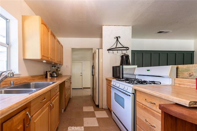 3080 State Highway 45, Glenn, CA 95943 - kitchen with white appliances, a sink, light countertops, and light flooring