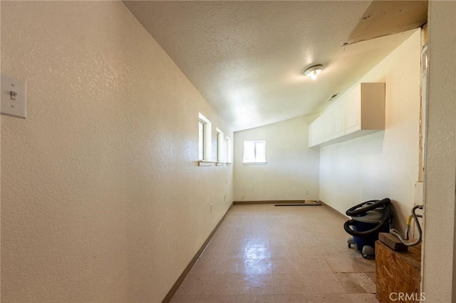 3080 State Highway 45, Glenn, CA 95943 - additional living space with vaulted ceiling, baseboards, light flooring, and a textured ceiling
