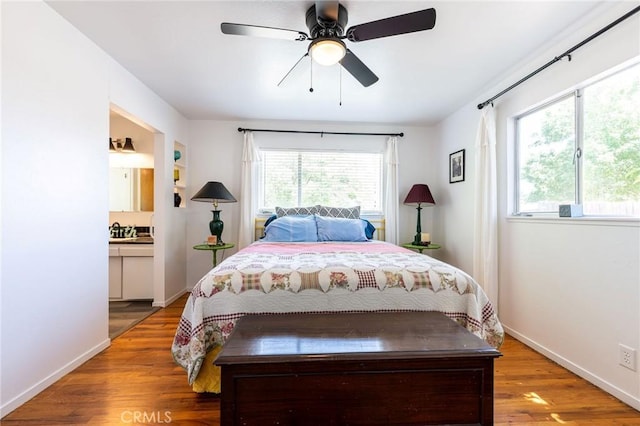 3080 State Highway 45, Glenn, CA 95943 - bedroom with wood finished floors, baseboards, ensuite bathroom, and a ceiling fan