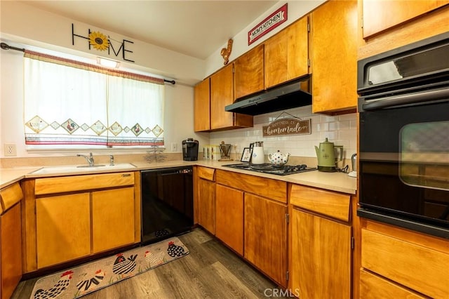 3080 State Highway 45, Glenn, CA 95943 - kitchen with black appliances, a sink, under cabinet range hood, dark wood-style flooring, and light countertops