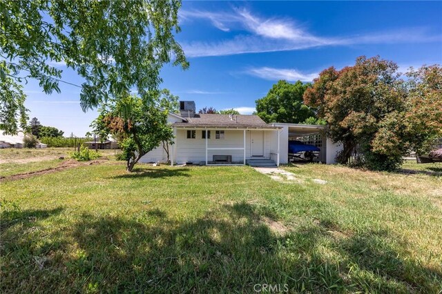 3080 State Highway 45, Glenn, CA 95943 - back of property with entry steps, a yard, a carport, and a chimney