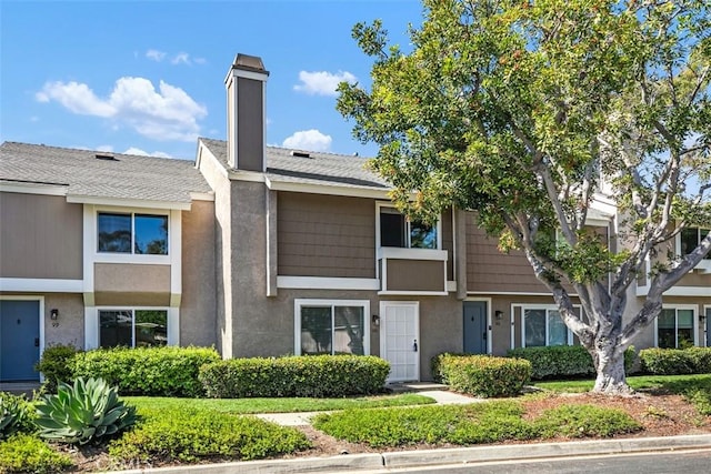 101 Briarwood Unit 3, Irvine, CA 92604 - townhome / multi-family property with a chimney, stucco siding, and a shingled roof