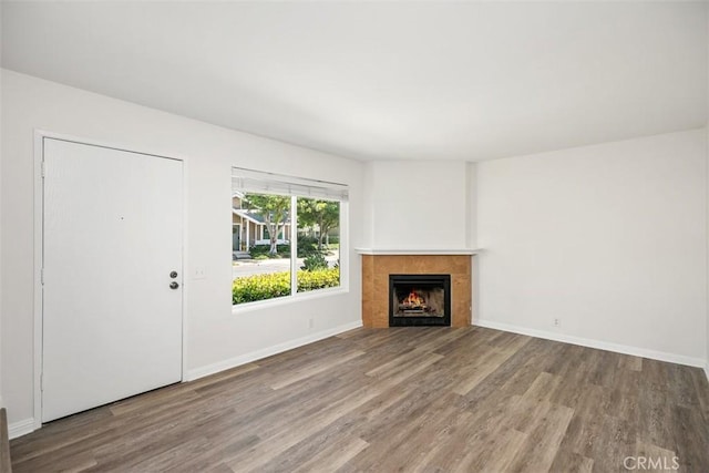 101 Briarwood Unit 3, Irvine, CA 92604 - unfurnished living room featuring wood finished floors and a tiled fireplace