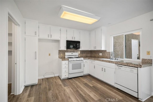 101 Briarwood Unit 3, Irvine, CA 92604 - kitchen with white appliances, white cabinets, dark wood finished floors, and backsplash