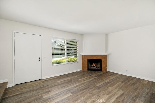 101 Briarwood Unit 3, Irvine, CA 92604 - unfurnished living room featuring wood finished floors and a tiled fireplace