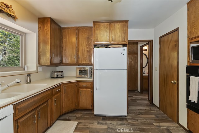 1249 Yellowstone Dr, Lake Arrowhead, CA 92352 - kitchen with white appliances, a sink, dark wood-style floors, light countertops, and brown cabinets