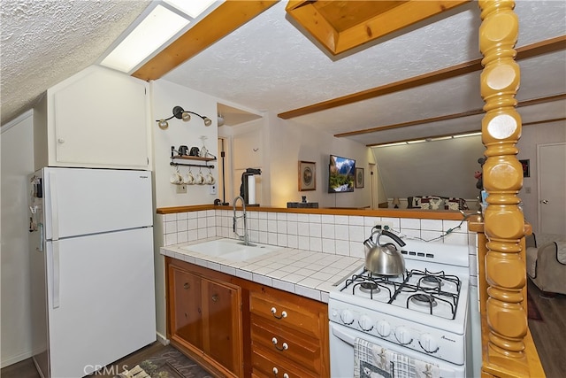 1249 Yellowstone Dr, Lake Arrowhead, CA 92352 - kitchen with white appliances, a sink, tile counters, tasteful backsplash, and a textured ceiling