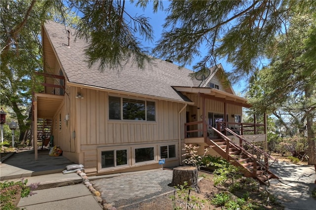 1249 Yellowstone Dr, Lake Arrowhead, CA 92352 - back of property with stairs, board and batten siding, roof with shingles, and a patio