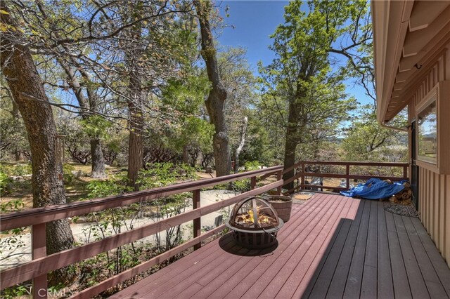 1249 Yellowstone Dr, Lake Arrowhead, CA 92352 - wooden deck featuring view of wooded area