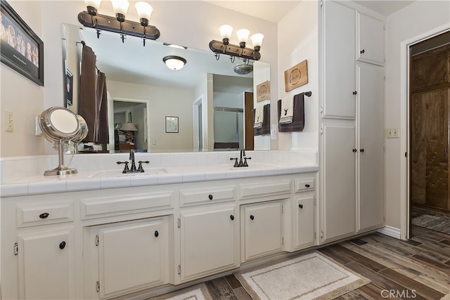 1249 Yellowstone Dr, Lake Arrowhead, CA 92352 - bathroom with double vanity, wood finished floors, and a shower