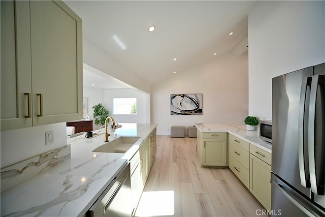 21651 Hilaria, Huntington Beach, CA 92646 - kitchen featuring freestanding refrigerator, a sink, dishwashing machine, vaulted ceiling, and a peninsula
