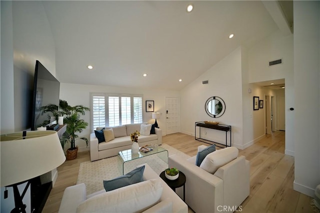 21651 Hilaria, Huntington Beach, CA 92646 - living room with high vaulted ceiling, recessed lighting, light wood finished floors, and baseboards