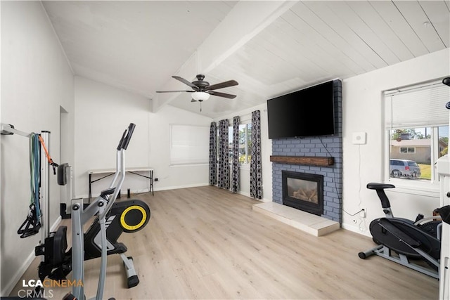 3113 Occidental St, Bakersfield, CA 93305 - workout area with vaulted ceiling, healthy amount of natural light, a fireplace, wood finished floors, and baseboards