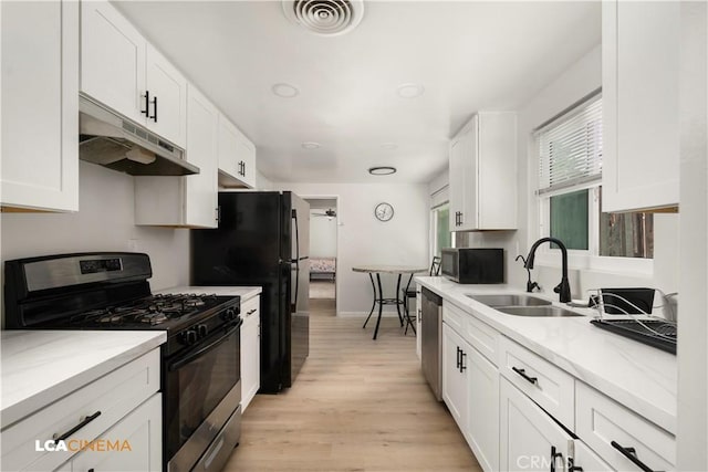 3113 Occidental St, Bakersfield, CA 93305 - kitchen featuring black appliances, under cabinet range hood, a sink, and white cabinetry