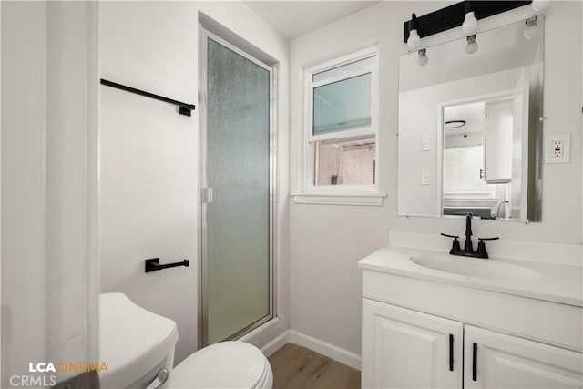 3113 Occidental St, Bakersfield, CA 93305 - full bathroom featuring toilet, wood finished floors, a stall shower, vanity, and baseboards