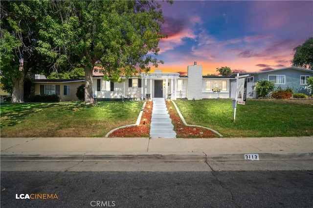 3113 Occidental St, Bakersfield, CA 93305 - view of front facade featuring a lawn and a chimney