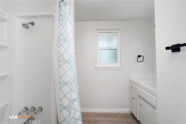 3113 Occidental St, Bakersfield, CA 93305 - full bathroom featuring wood finished floors, vanity, shower / tub combo, and baseboards
