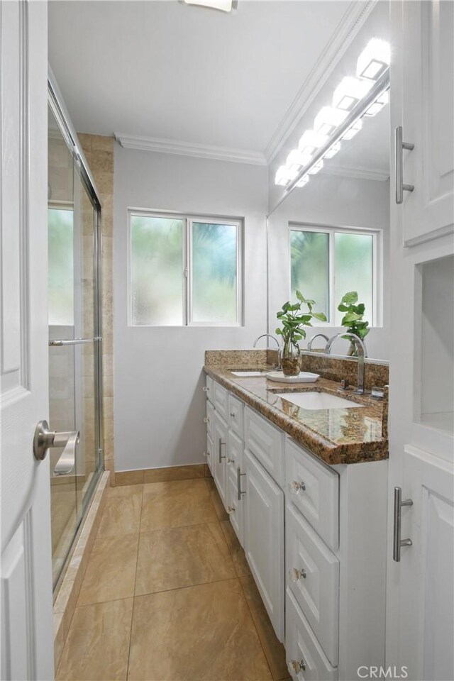3950 E De Ora Way, Long Beach, CA 90815 - bathroom with ornamental molding, a stall shower, double vanity, baseboards, and tile patterned floors