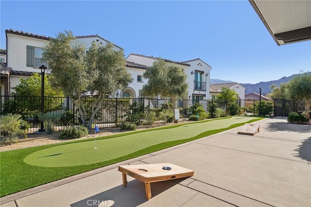 80218 Whisper Rock Way, La Quinta, CA 92253 - view of community featuring a putting area, fence, and a patio area