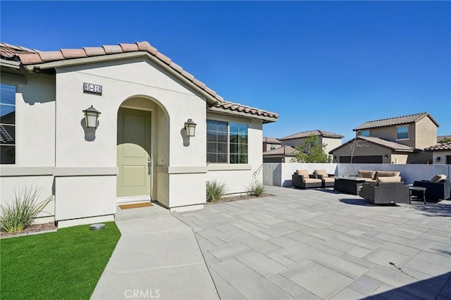 80218 Whisper Rock Way, La Quinta, CA 92253 - property entrance featuring outdoor lounge area, stucco siding, a patio area, and a tiled roof