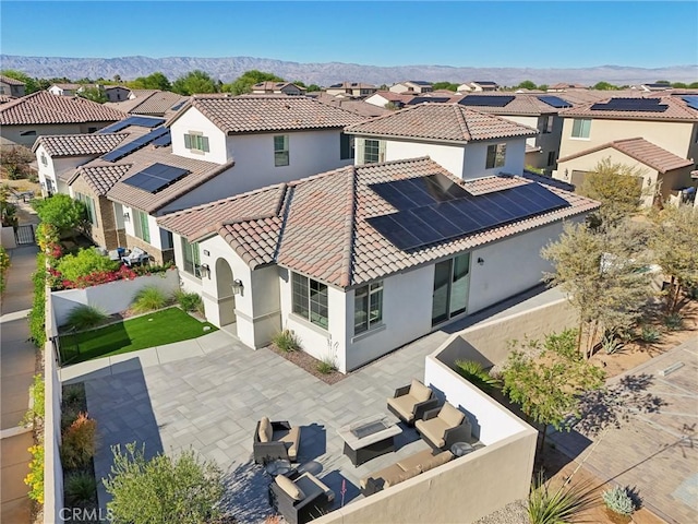 80218 Whisper Rock Way, La Quinta, CA 92253 - rear view of property featuring a residential view, stucco siding, solar panels, a patio area, and a tiled roof